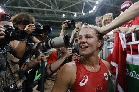 Canada's Erica Elizabeth Wiebe celebrates with fans after winning the gold medal during the women's 75-kg freestyle wrestling competition at the 2016 Summer Olympics in Rio de Janeiro, Brazil, Thursday, Aug. 18, 2016. (AP Photo/Markus Schreiber)