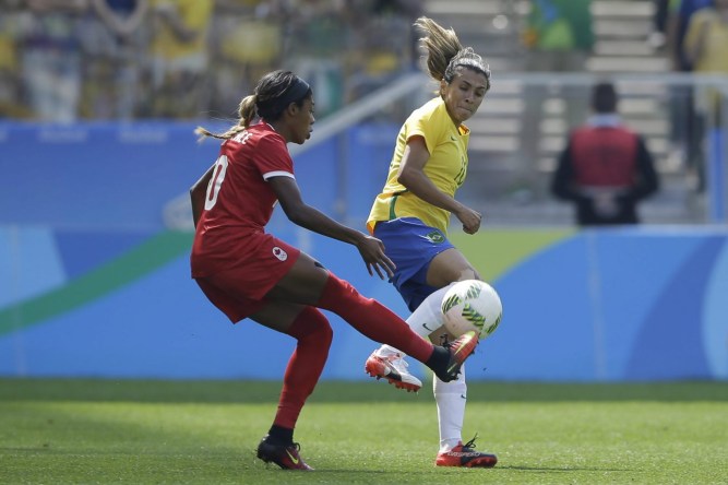 Brazil's Marta, right, and Canada's Ashley Lawrence compete for the ball during the bronze medal match of the women's Olympic football tournament between Brazil and Canada at the Arena Corinthians stadium in Sao Paulo, Friday Aug. 19, 2016. (AP Photo/Nelson Antoine)