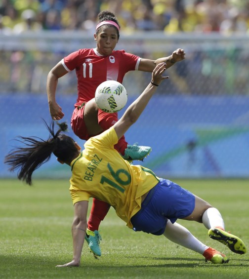 Canada's Desiree Scott, top, kicks the ball under pressure by Brazil's Beatriz during the bronze medal match of the women's Olympic football tournament between Brazil and Canada at the Arena Corinthians stadium in Sao Paulo, Friday Aug. 19, 2016. (AP Photo/Nelson Antoine)