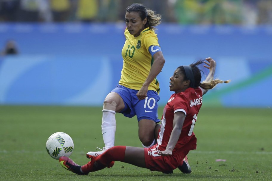 Brazil's Marta is challenged by Canada's Ashley Lawrence during the bronze medal match of the women's Olympic football tournament between Brazil and Canada at the Arena Corinthians stadium in Sao Paulo, Friday Aug. 19, 2016. (AP Photo/Nelson Antoine)