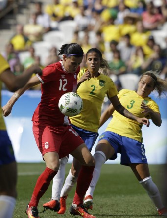 Canada's Christine Sinclair, left, scores her side's 2nd goal during the bronze medal match of the women's Olympic football tournament between Brazil and Canada at the Arena Corinthians stadium in Sao Paulo, Friday Aug. 19, 2016. (AP Photo/Nelson Antoine)