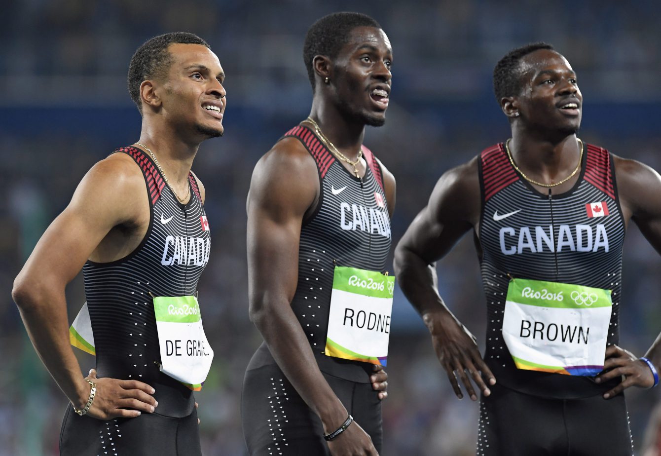 Canada's Andre De Grasse, left to right, Brendon Rodney and Aaron Brown watch the scoreboard following the men's 4x100-metre relay final at the 2016 Summer Olympics in Rio de Janeiro, Brazil on Friday, August 19, 2016. THE CANADIAN PRESS/Frank Gunn