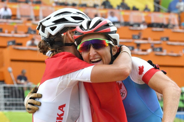 Canada's Catharine Pendrel, right, celebrates winning bronze with silver medallist Maja Wloszczowska of Poland in the women's mountain bike final at the 2016 Olympic Summer Games in Rio de Janeiro, Brazil on Saturday, Aug. 20, 2016. THE CANADIAN PRESS/Sean Kilpatrick