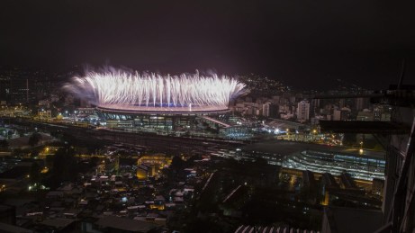 Fireworks explode above the Maracana stadium during the closing ceremony for the Summer Olympics, seen from the Mangueira slum in Rio de Janeiro, Brazil, Sunday, Aug. 21, 2016. (AP Photo/Felipe Dana)