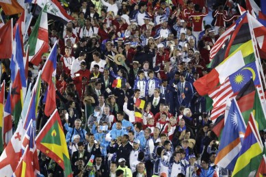 Athletes surrounded by flags march into the closing ceremony in the Maracana stadium at the 2016 Summer Olympics in Rio de Janeiro, Brazil, Sunday, Aug. 21, 2016. (AP Photo/Charlie Riedel)