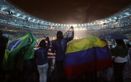 People wave flags from Brazil, the United States, and Colombia during the closing ceremony for the Summer Olympics inside Maracana stadium in Rio de Janeiro, Brazil, Sunday, Aug. 21, 2016. (AP Photo/Jae C. Hong)