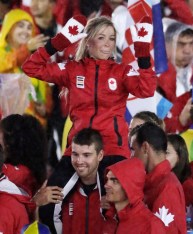Canadian athlete on shoulders of another Canadian athlete