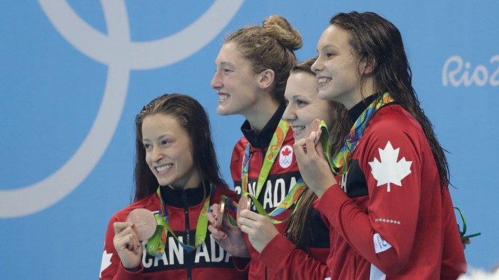 The women's 4x200m freestyle relay team celebrate their Olympic bronze medal on August 10, 2016 in Rio de Janeiro.