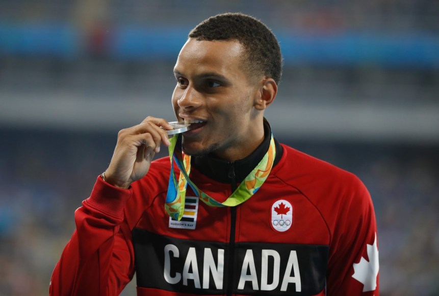 Rio 2016: Andre De Grasse Andre De Grase bites his silver medal on the podium