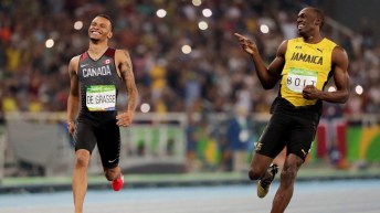 Andre De Grasse and Usain Boly share a laugh during the 200m semifinal at Rio 2016