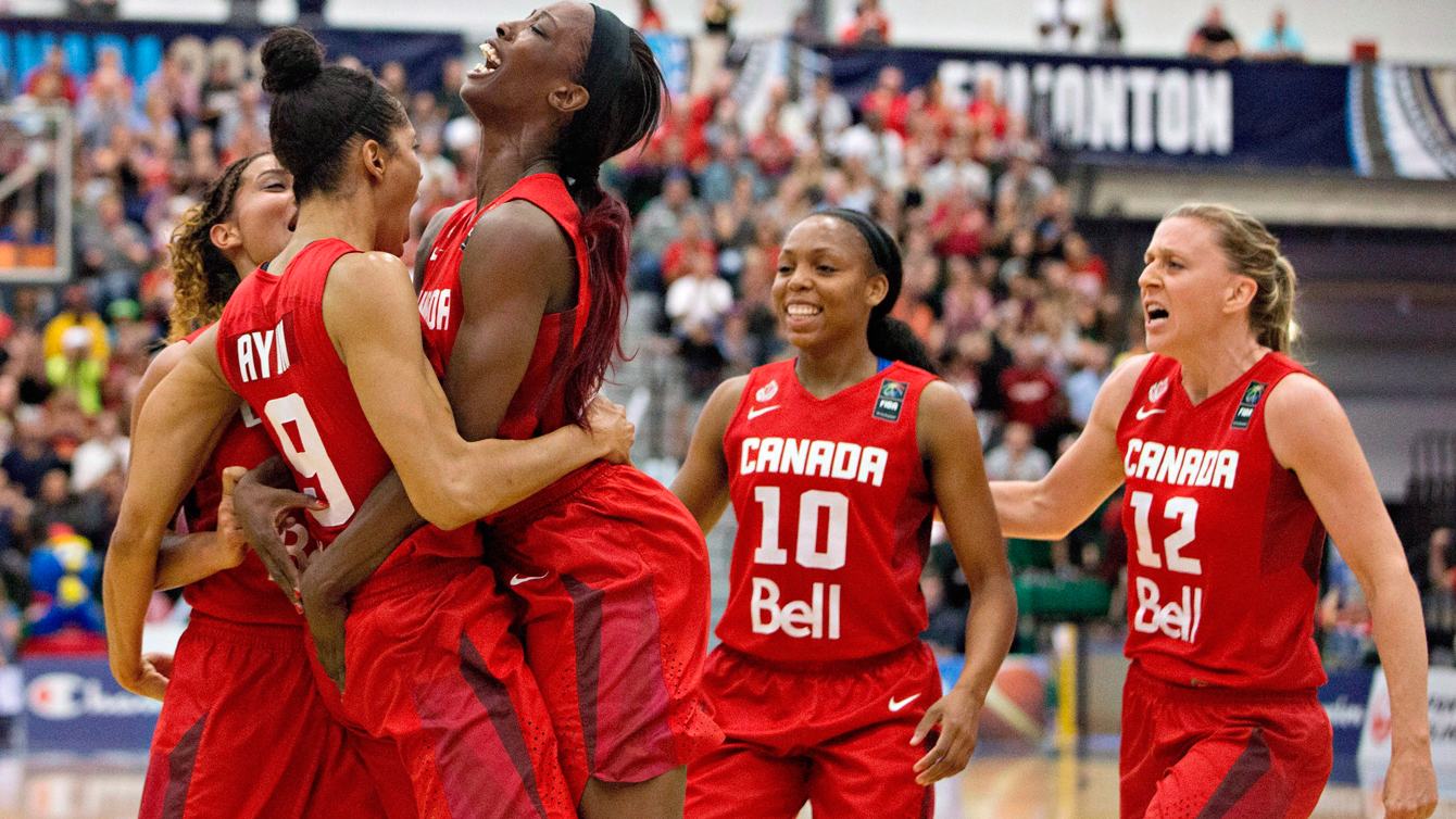 Canada's Miranda Ayim, left, and Tamara Tatham, 2nd left, embrace as fellow teammates Nirra Fields, 2nd right, and Lizanne Murphy, right, celebrate a basket against Cuba during first half action of the 2015 FIBA Americas Women's Championship Final in Edmonton, Alta., on Sunday, August 16, 2015. THE CANADIAN PRESS/Jason Franson