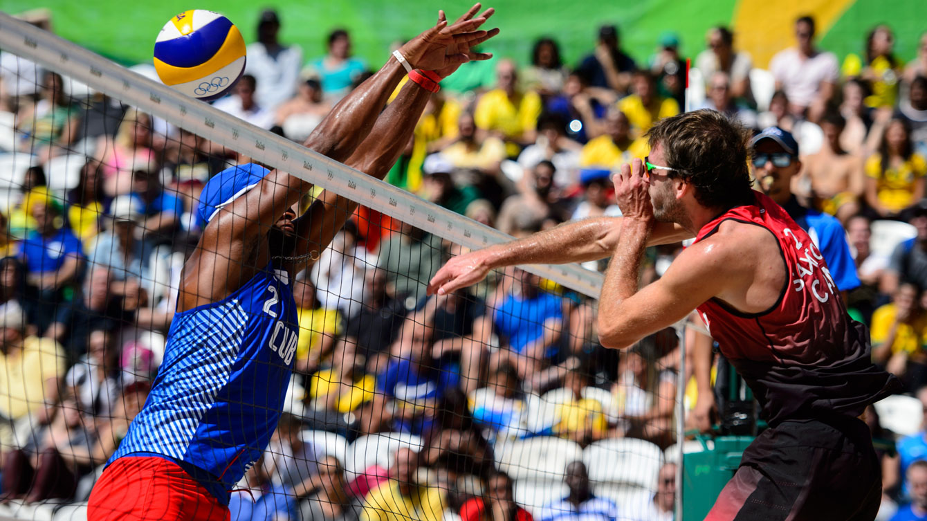 Ben Saxton attacks Cuba at the Rio 2016 beach volleyball tournament / Photo via FIVB