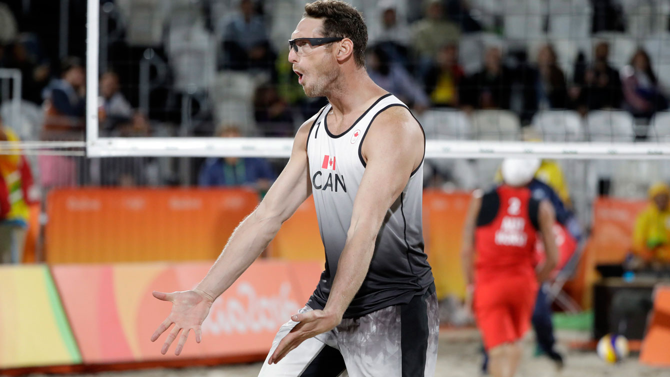 Canada's Josh Binstock celebrates a point against Austria during a men's beach volleyball match at the 2016 Summer Olympics in Rio de Janeiro, Brazil, Thursday, Aug. 11, 2016. (AP Photo/Marcio Jose Sanchez)