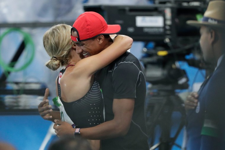 Brianne Theisen Eaton embracing husband Ashton Eaton after winning bronze in the women's heptathlon. (photo/ Jason Ransom)
