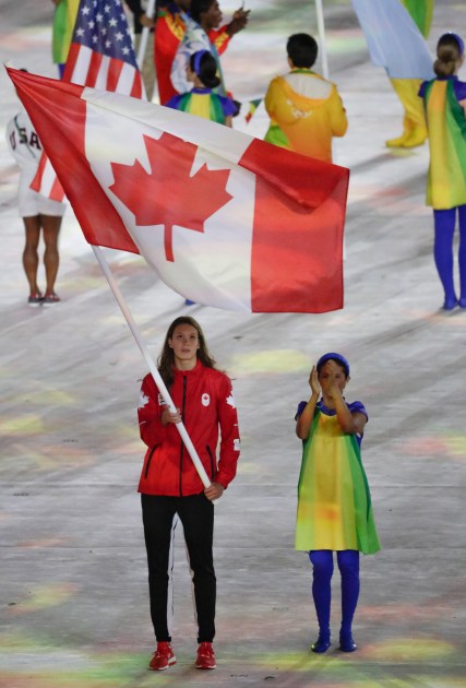 Penny Oleksiak carries the flag in the closing ceremonies during Rio 2016 on August 21, 2016. (COC/Jason Ransom)