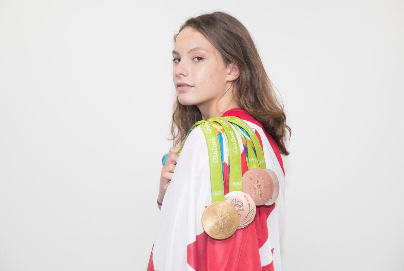 Penny Oleksiak poses with her four Olympic medals after being revealed as the Canadian Closing Ceremony at Rio 2016 (COC/Mark Blinch)