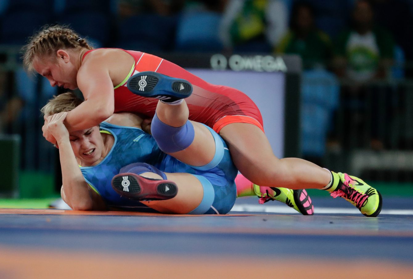 Canada's Erica Wiebe, in red, competes against Kazakhstan's Guzel Manyurova during the women's 75kg freestyle wrestling competition at the 2016 Summer Olympics in Rio de Janeiro, Brazil, Thursday, Aug. 18, 2016. (COC/Jason Ransom)