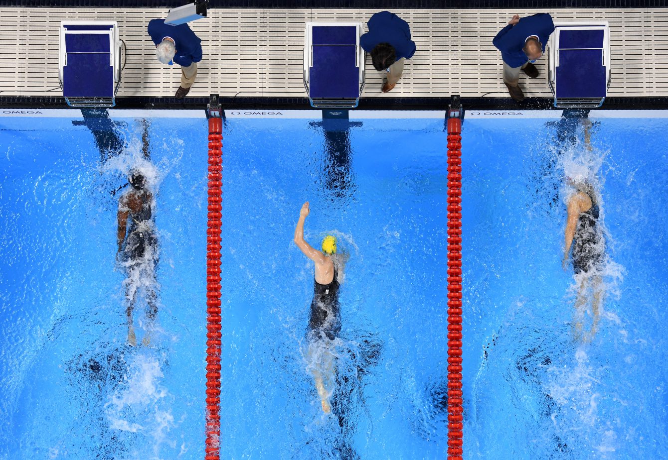 Canada's Penny Oleksiak, right, celebrates with a kiss from her father as  her sister and mom look on following her gold-medal performance at the  women's 100m freestyle finals during the 2016 Olympic