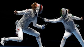 Eleanor Harvey of Canada, left, competes with Anissa Khelfaoui of Algeria women's individual foil event at the 2016 Summer Olympics in Rio de Janeiro, Brazil, Wednesday, Aug. 10, 2016. (AP Photo/Andrew Medichini)