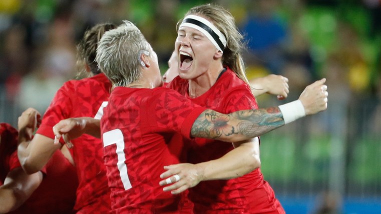 Karen Paquin hugs captain Jen Kish after winning bronze for rugby on August 8, 2016.