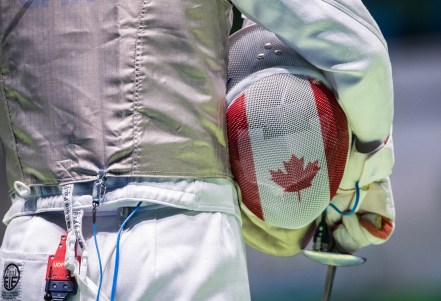 Canada's Maximilien van Haaster holds his helmet as he prepares to compete against Venezuela's Antonio Leal in their Men's Foil Individual Table of 64 fencing match at the Olympic games in Rio de Janeiro, Brazil, Sunday August 7, 2016. COC Photo/Mark Blinch