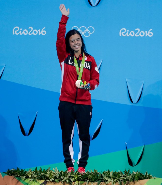 Meaghan Benfeito stands on the podium 
