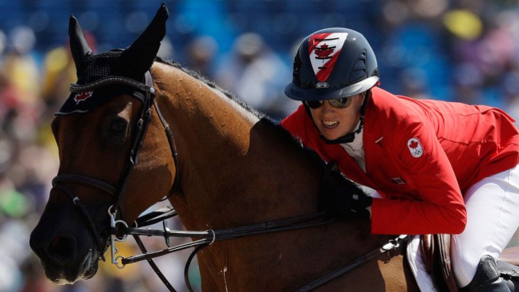 Amy Millar Amy Millar on horse jumping during equestrian event