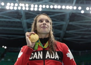 Canada's Penny Oleksiak with her gold medal after finishing first in the women's 100-meter freestyle during the swimming competitions at the 2016 Summer Olympics, Thursday, Aug. 11, 2016, in Rio de Janeiro, Brazil. (COC photo/JasonRansom)