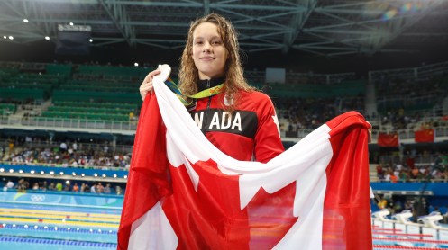 Penny Oleksiak poses with her silver medal after finishing second in the 100m butterfly