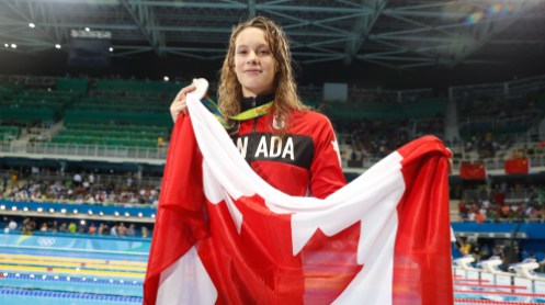 PennyOleksiak_100mFly_Silver_MarkBlinchPhoto-1-2 Penny Oleksiak poses with her silver medal after finishing second in the 100m butterfly