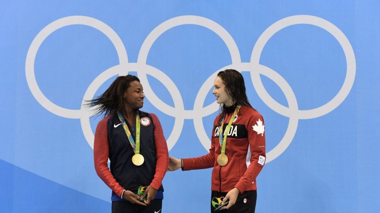 Penny Oleksiak, Simone Manuel Penny Oleksiak (right) and Simone Manuel atop the Olympic podium at Rio 2016 on August 11, 2016.