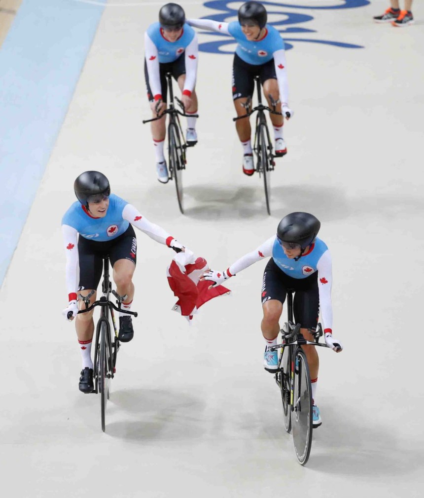 Canada's women's team pursuit team with the Canadian flag after winning the bronze medal at the velodrome at the Olympic games in Rio de Janeiro, Brazil, Saturday August 13, 2016. (photo/ Mark Blinch)