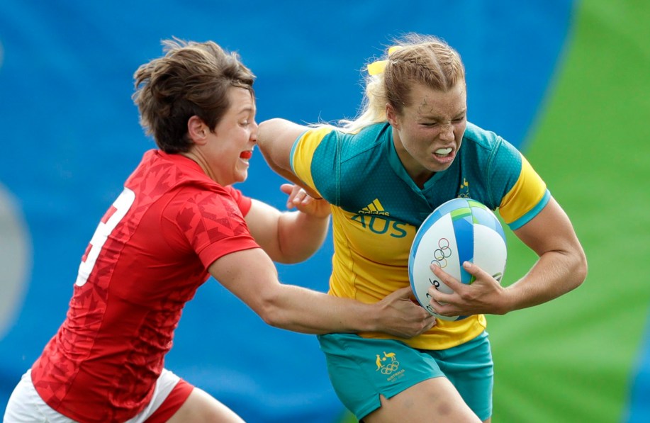 Australia's Emma Tonegato, avoids a tackled by Canada's Ghislaine Landry, during the women's rugby sevens semi final match at the Summer Olympics in Rio de Janeiro, Brazil, Monday, Aug. 8, 2016. (AP Photo/Themba Hadebe)