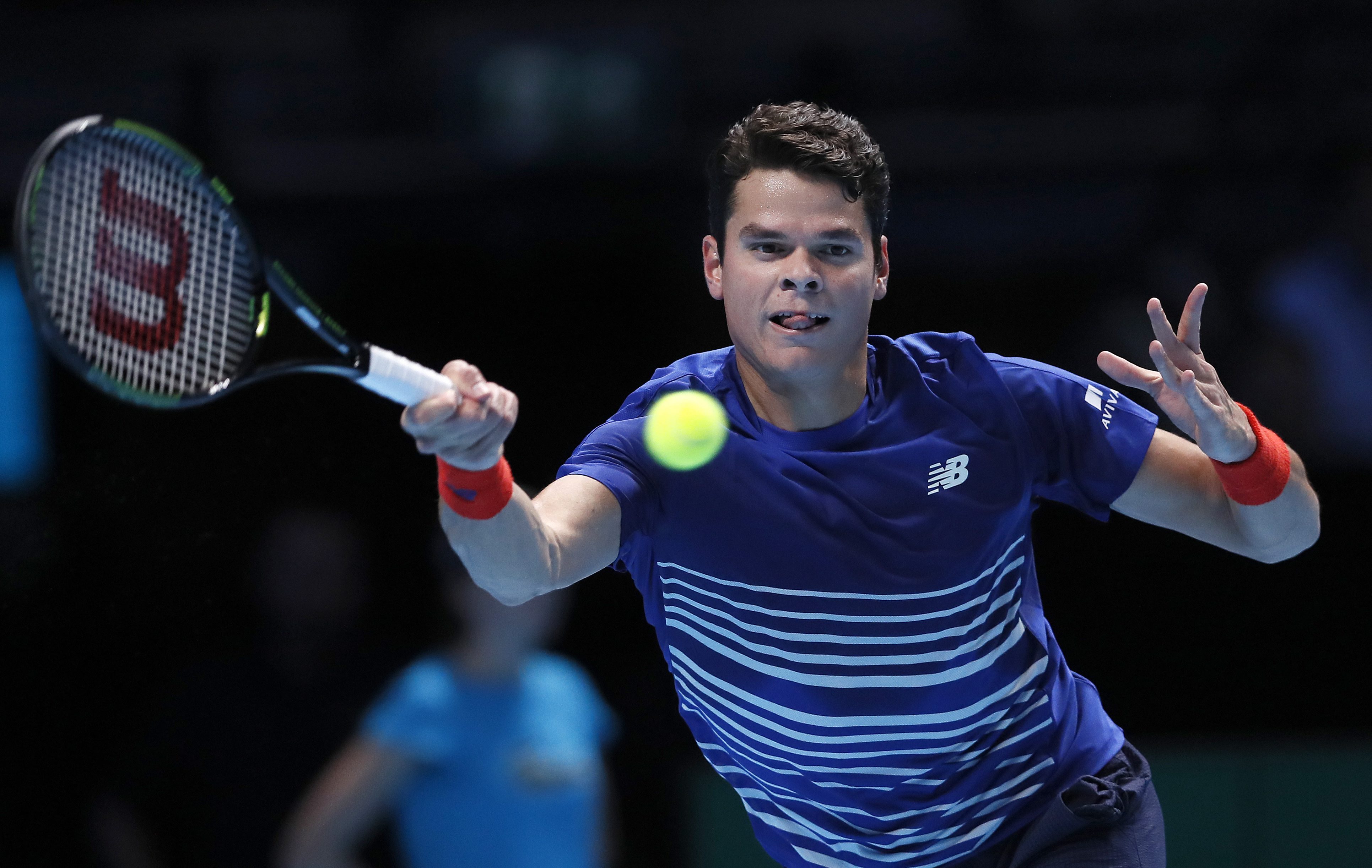 Milos Raonic of Canada plays a return to Dominic Thiem of Austria during their ATP World Tour Finals singles tennis match at the O2 Arena in London, Thursday, Nov. 17, 2016. (AP Photo/Kirsty Wigglesworth)