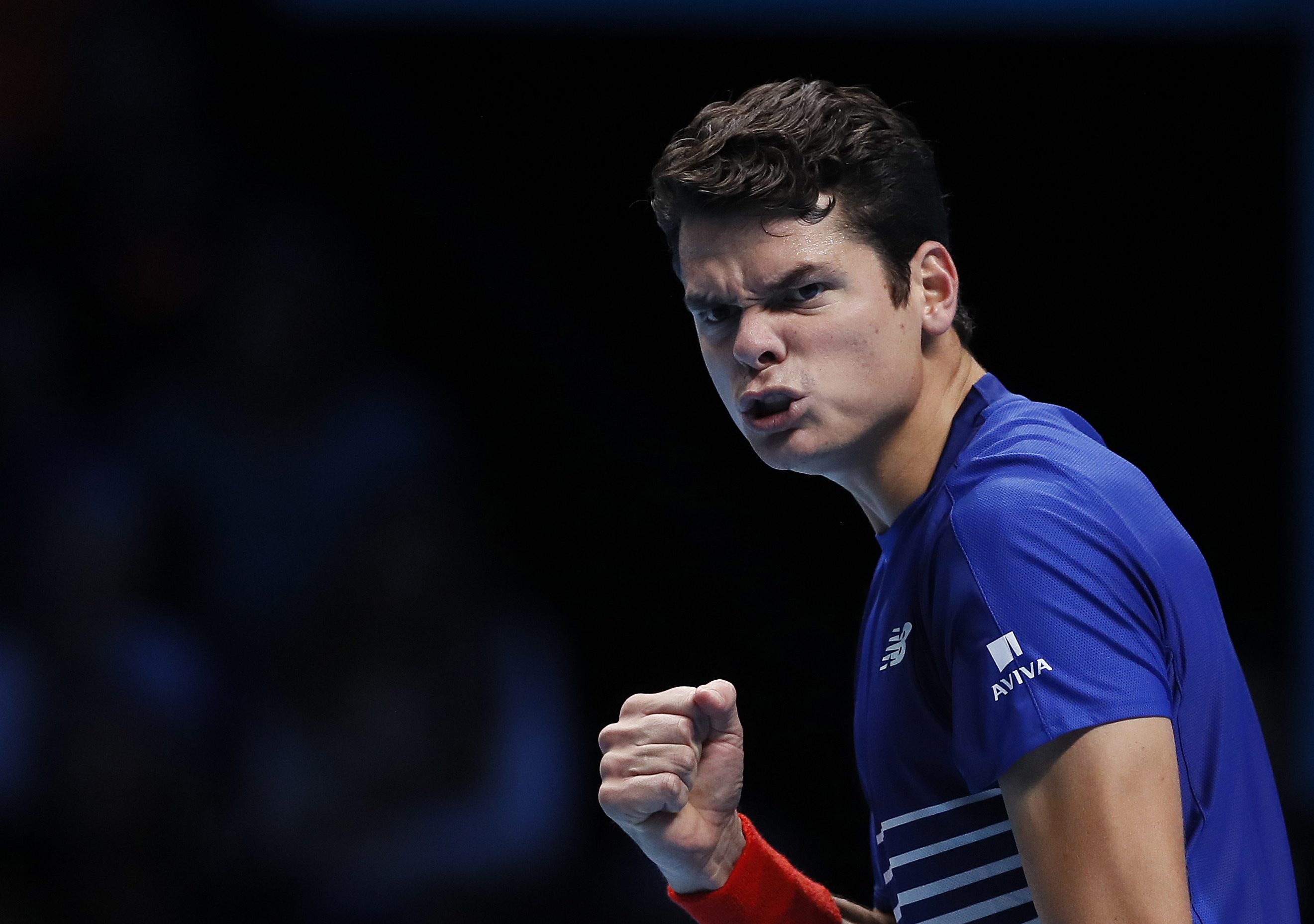Milos Raonic of Canada celebrates winning a point after a return to Dominic Thiem of Austria during their ATP World Tour Finals singles tennis match at the O2 Arena in London, Thursday, Nov. 17, 2016. (AP Photo/Kirsty Wigglesworth)