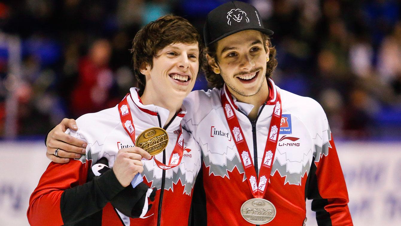 Charle Cournoyer et Samuel Girard celebrate finishing 1-2 in the 1000m at the World Cup opener in Calgary, Nov. 6 2016. (THE CANADIAN PRESS/Jeff McIntosh)