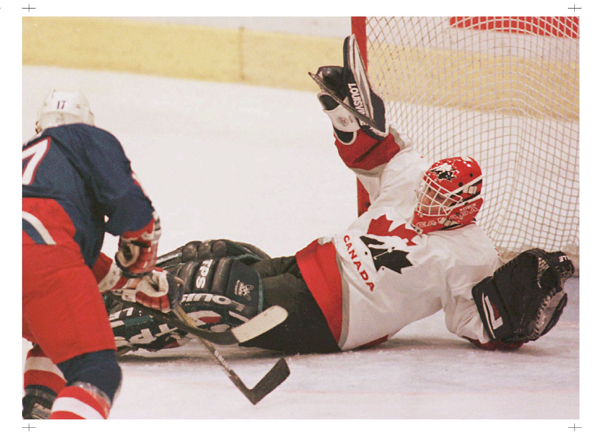 Team Canada goaltender Marc Denis makes the save off USA's Joseph Corvo during first period action at the World Junior Hockey Championships in Geneva Saturday. Canada beat the U.S. 2-0 to win their fifth consecutive title.(CP PHOTO/Ryan Remiorz)