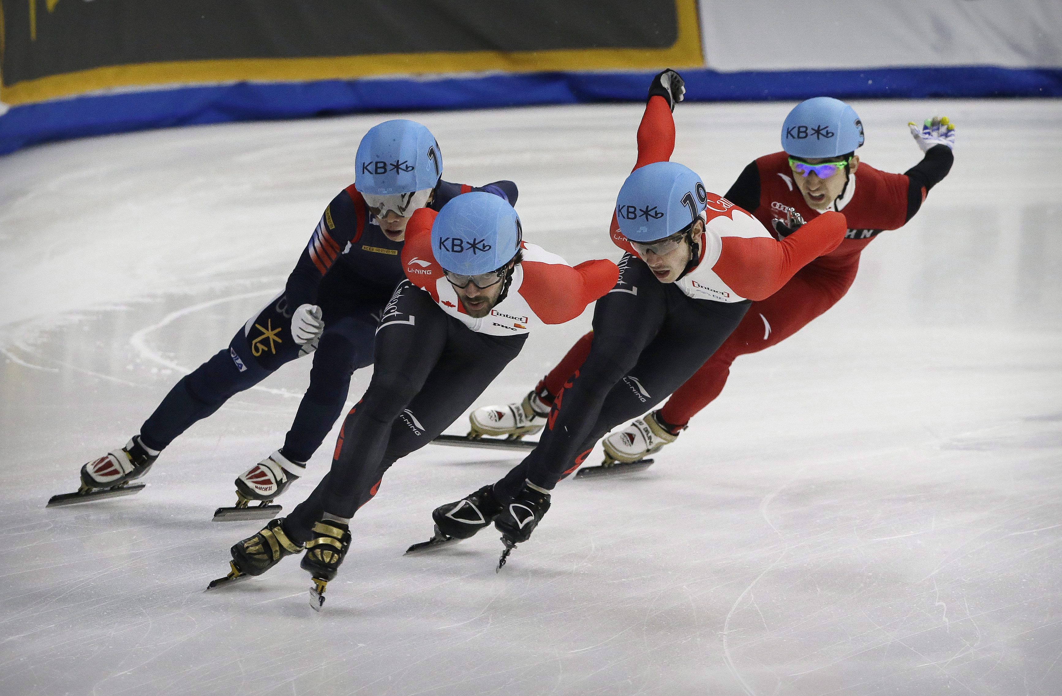 Charles Hamelin, second from left, of Canada, competes against Seo Yi Ra, left, of South Korea, Samuel Girard, second from right, of Canada and Wu Dajing, right, of China during the men's 1000 meter final race at the ISU World Cup Short Track Speed Skating competition in Seoul, South Korea, Sunday, March 13, 2016. Hamelin finished the race while Girard took second and Wu third. (AP Photo/Ahn Young-joon)