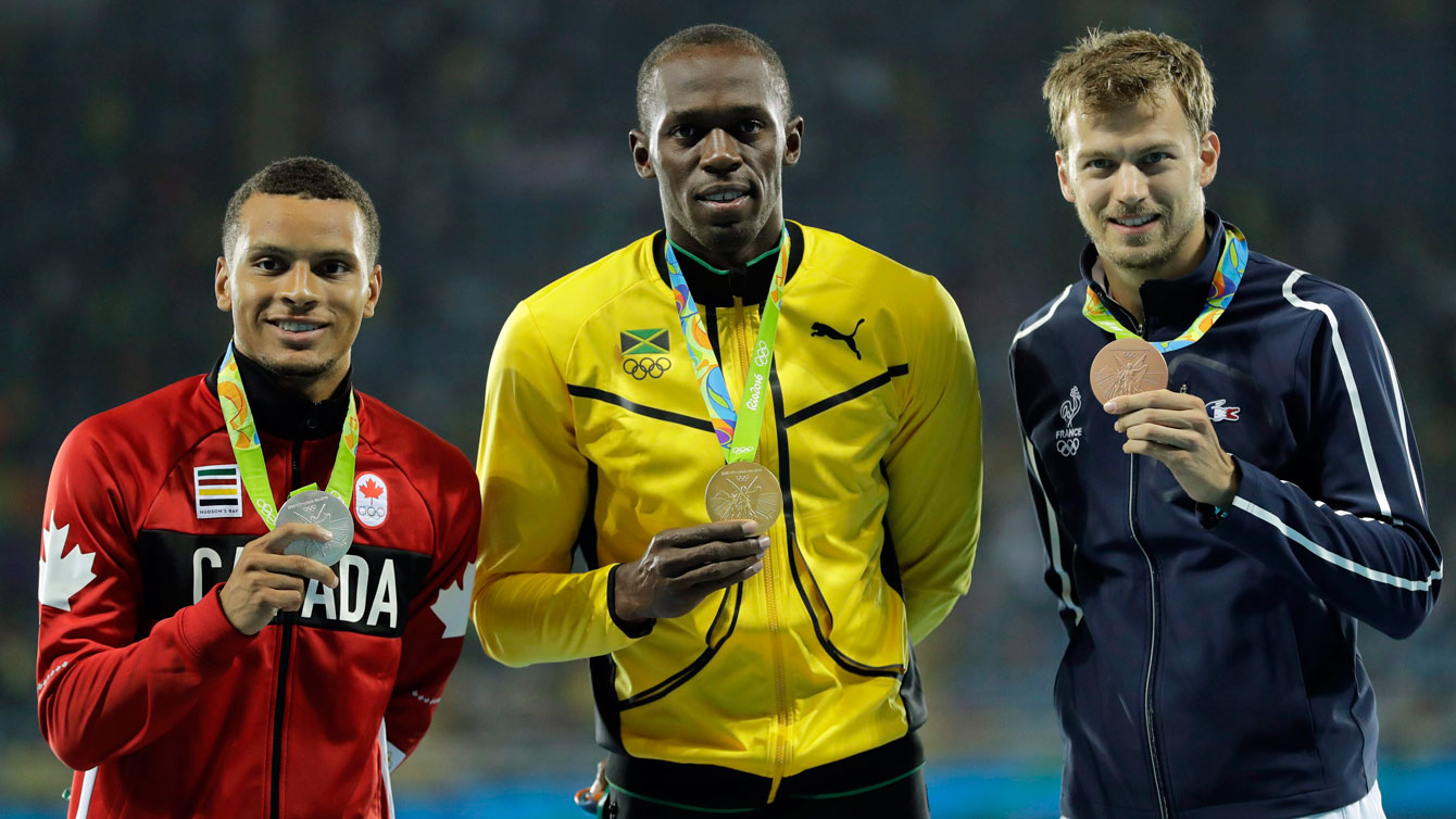 Andre De Grasse stands on men's 200m podium at Rio 2016 after winning silver. (AP Photo/Jae C. Hong)