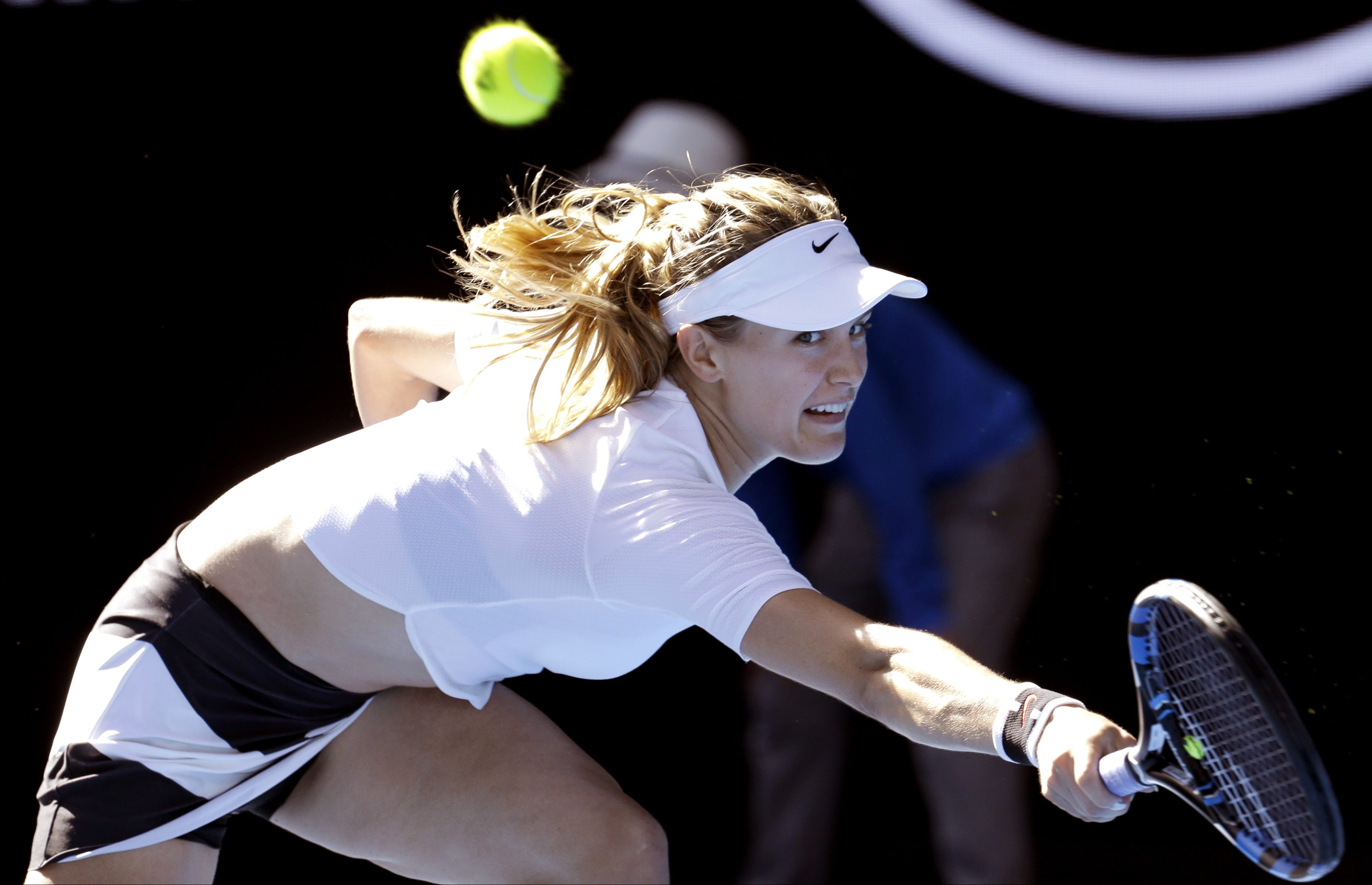 Canada's Eugenie Bouchard reaches for a return to China's Peng Shuai during their second round match at the Australian Open tennis championships in Melbourne, Australia, Wednesday, Jan. 18, 2017. (AP Photo/Aaron Favila)