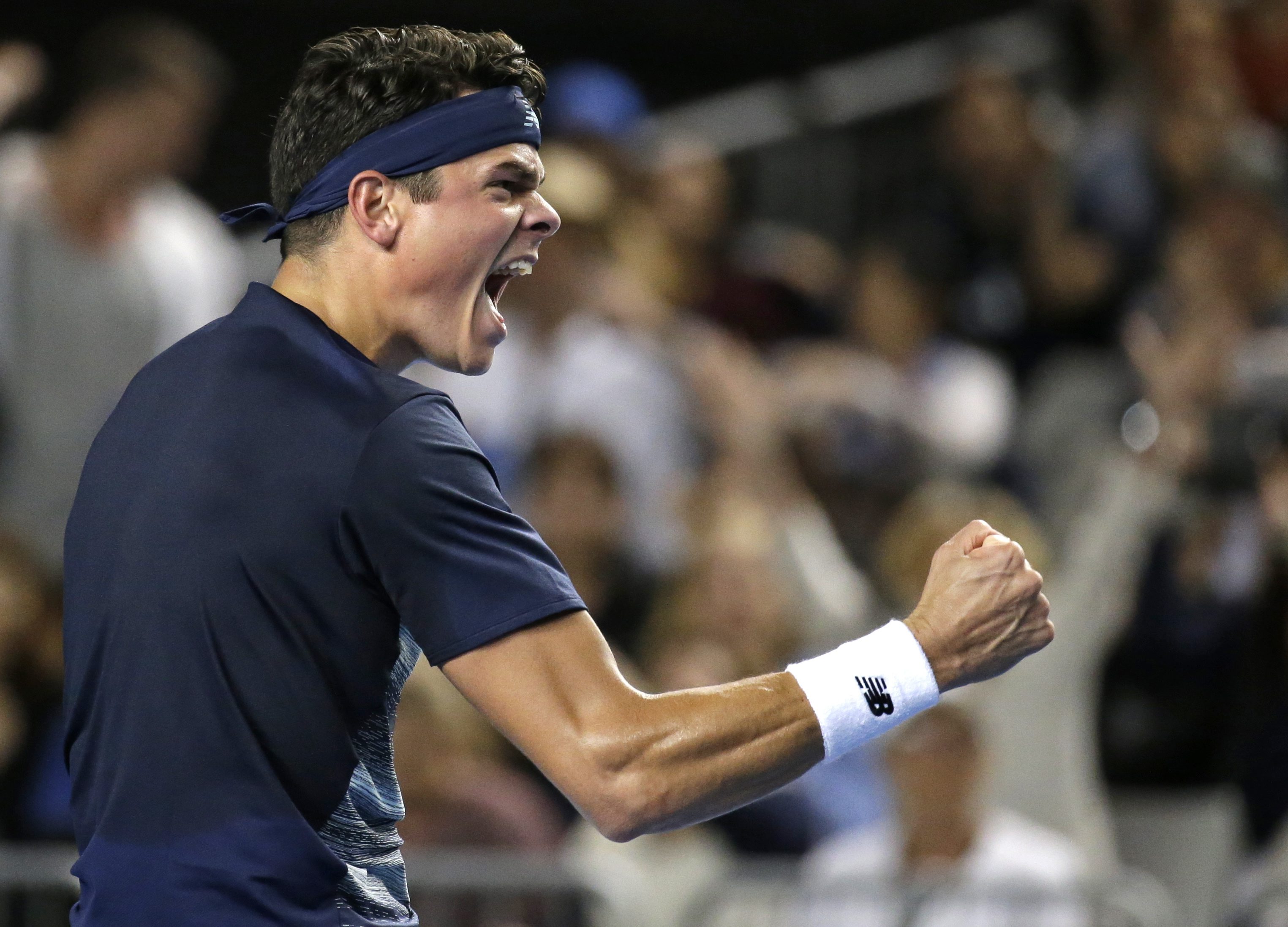 Canada's Milos Raonic celebrates after defeating France's Gilles Simon during their third round match at the Australian Open tennis championships in Melbourne, Australia, Saturday, Jan. 21, 2017. (AP Photo/Aaron Favila)