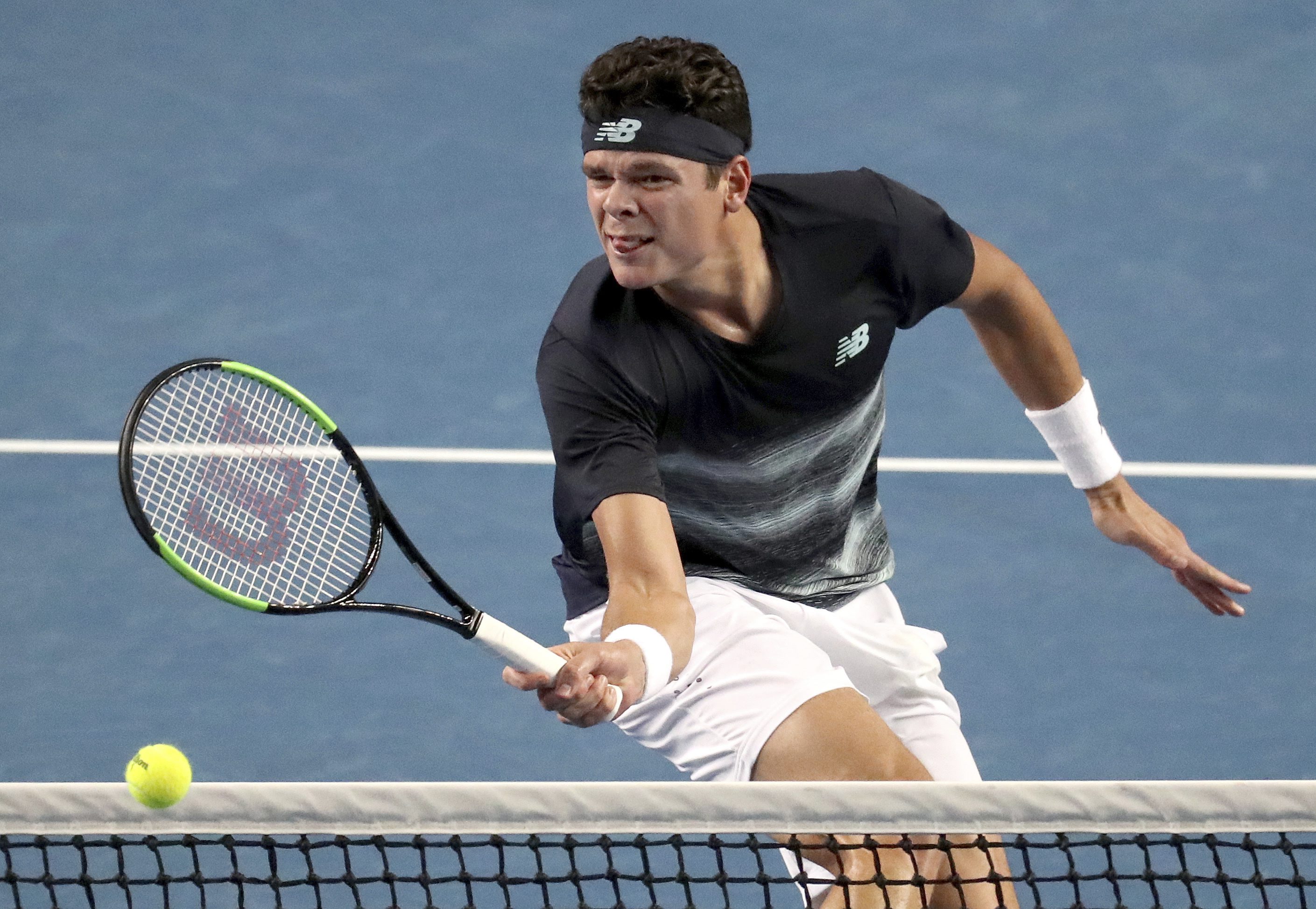 Canada's Milos Raonic hits a forehand to Spain's Roberto Bautista Agut during their fourth round match at the Australian Open tennis championships in Melbourne, Australia, Monday, Jan. 23, 2017. (AP Photo/Aaron Favila)