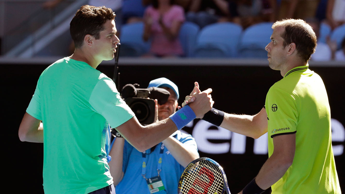 Milos Raonic is congratulated by Luxembourg's Gilles Muller after winning their second round meeting at the Australian Open on Jan. 19, 2017. (AP Photo/Aaron Favila)