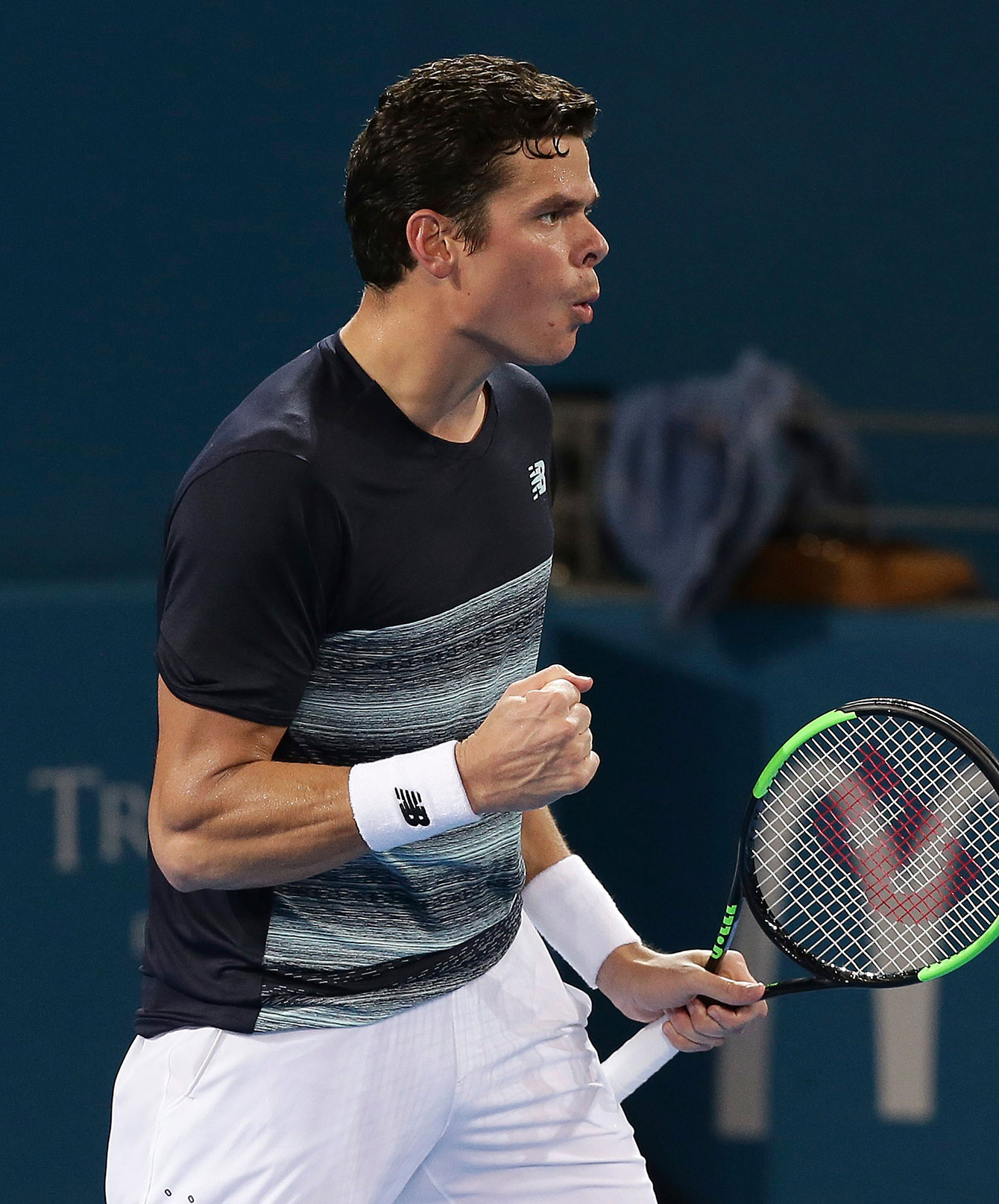 Milos Raonic celebrates the second set-winning point against Rafa Nadal at the Brisbane International on January 6, 2016.