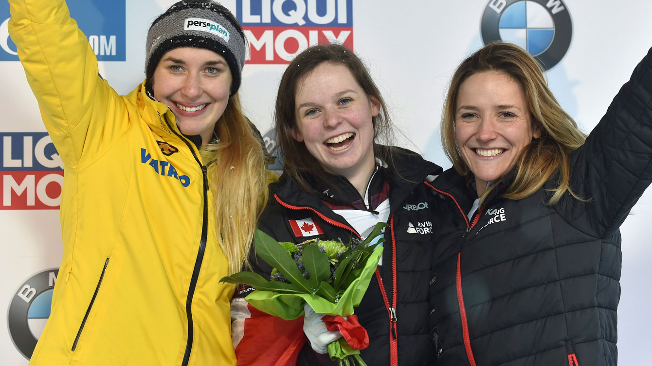 Elisabeth Vathje and Mirela Rahneva celebrate finishing first and third respectively at the Skeleton World Cup in Winterberg, Germany on Jan. 15, 2017. (Caroline Seidel/dpa via AP)