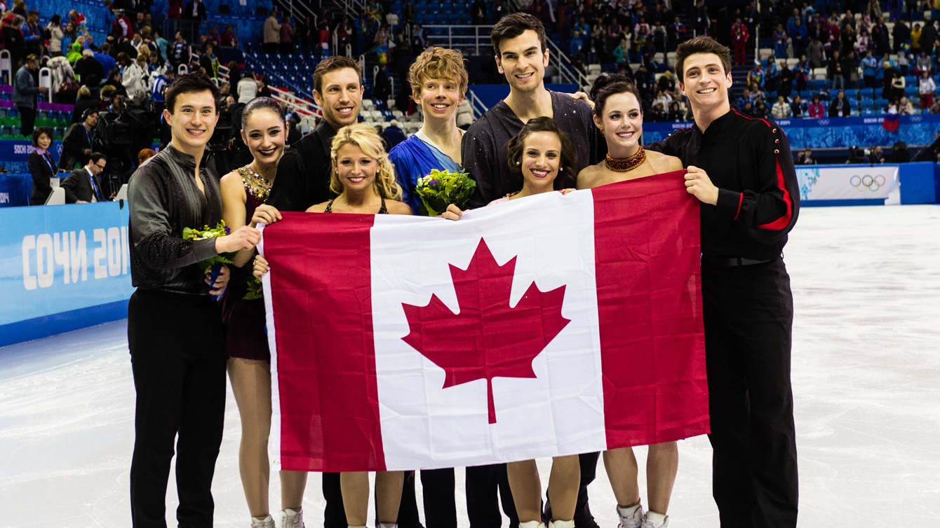 Kevin (centre) and the Canadian figure skating team celebrate their team silver medal. Photo: Winston Chow