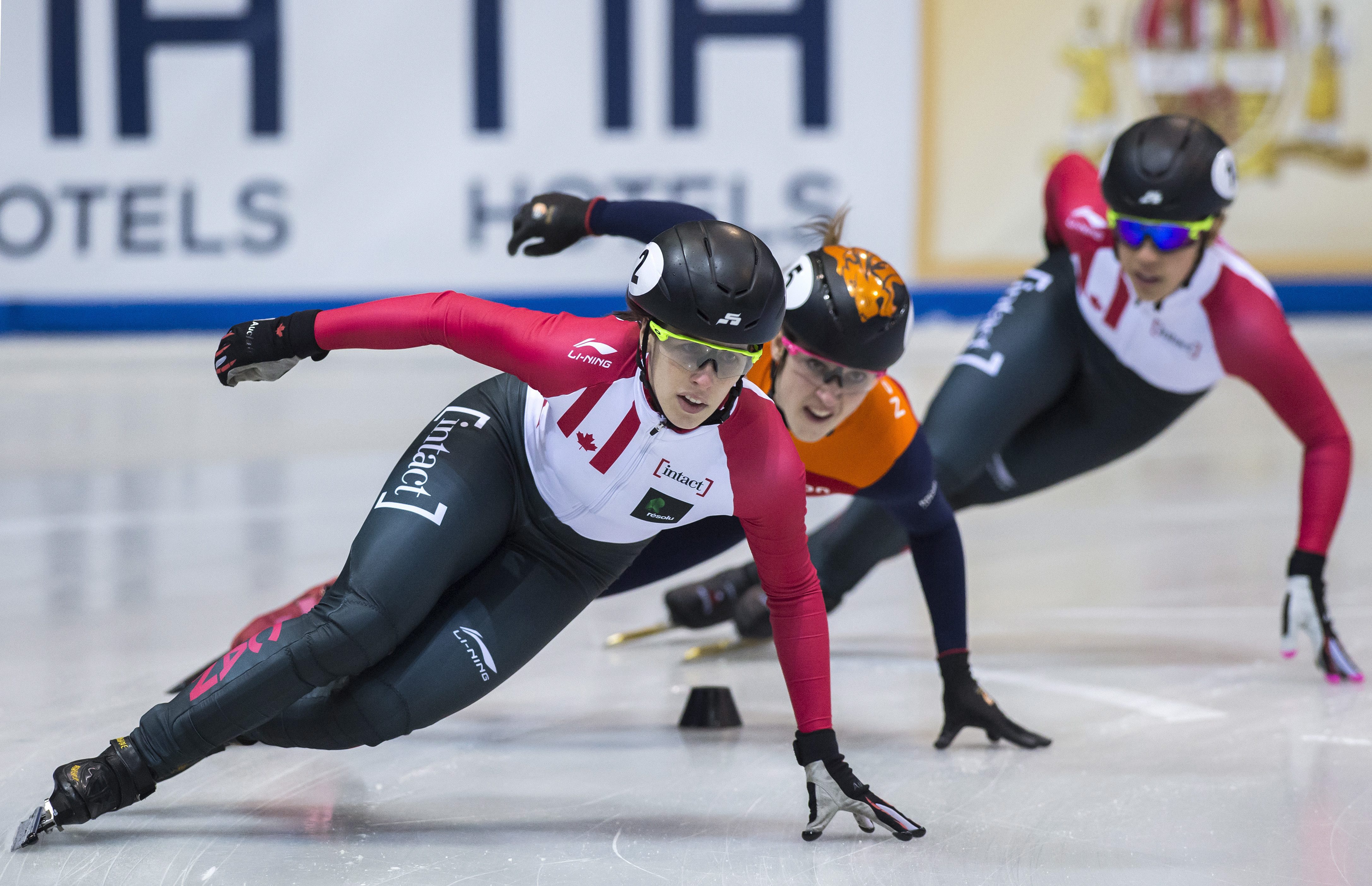 Winner Marianne St-Gelais of Canada, left, skates in front of second placed Suzanne Schulting of Netherlands, center, and third placed Valerie Maltais of Canada, right, during the women 1,000 meters final race at the short track speed skating World Cup in Dresden, Germany, Saturday, Feb. 4, 2017. (AP Photo/Jens Meyer)