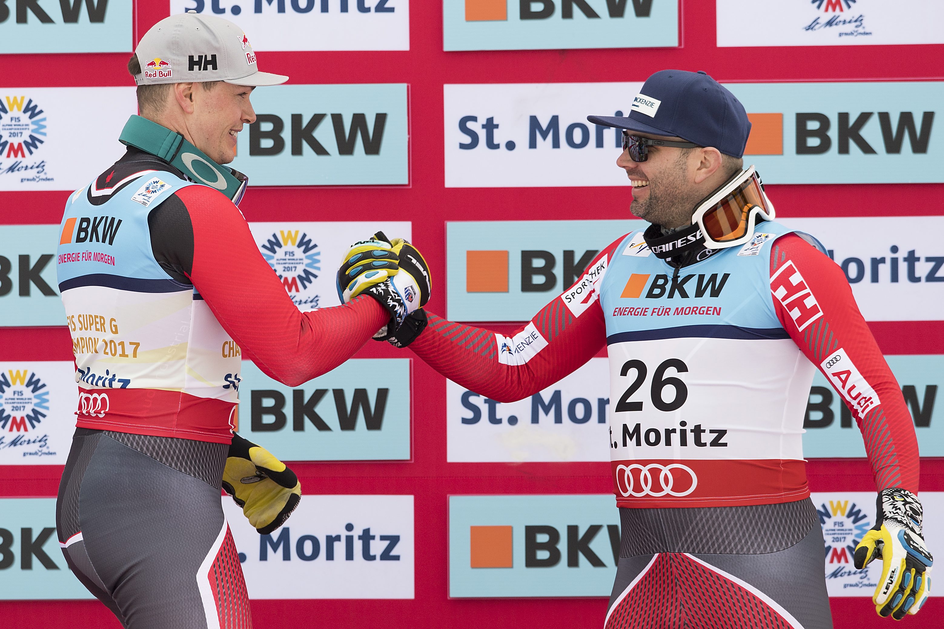 Gold medalist Erik Guay of Canada, left, and bronze medalist Manuel Osborne-Paradis of Canada, right, shake hands during the men's Super-G flower ceremony at the 2017 Alpine Skiing World Championships in St. Moritz, Switzerland, Wednesday, Feb. 8, 2017. (Peter Schneider/Keystone via AP)