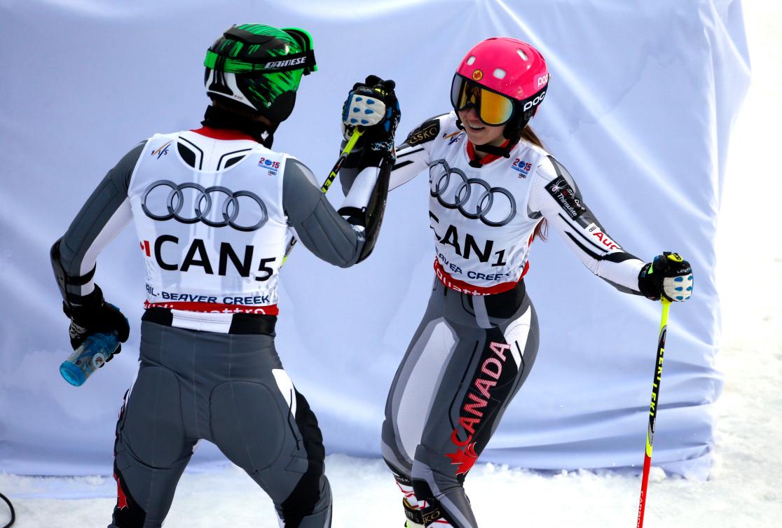 Canada's Candace Crawford, right, celebrates with Canada's Phil Brown competes against xx during the mixed worlds team skiing event at the alpine skiing world championships, Tuesday, Feb. 10, 2015, in Vail, Colo. (AP Photo/John Locher)