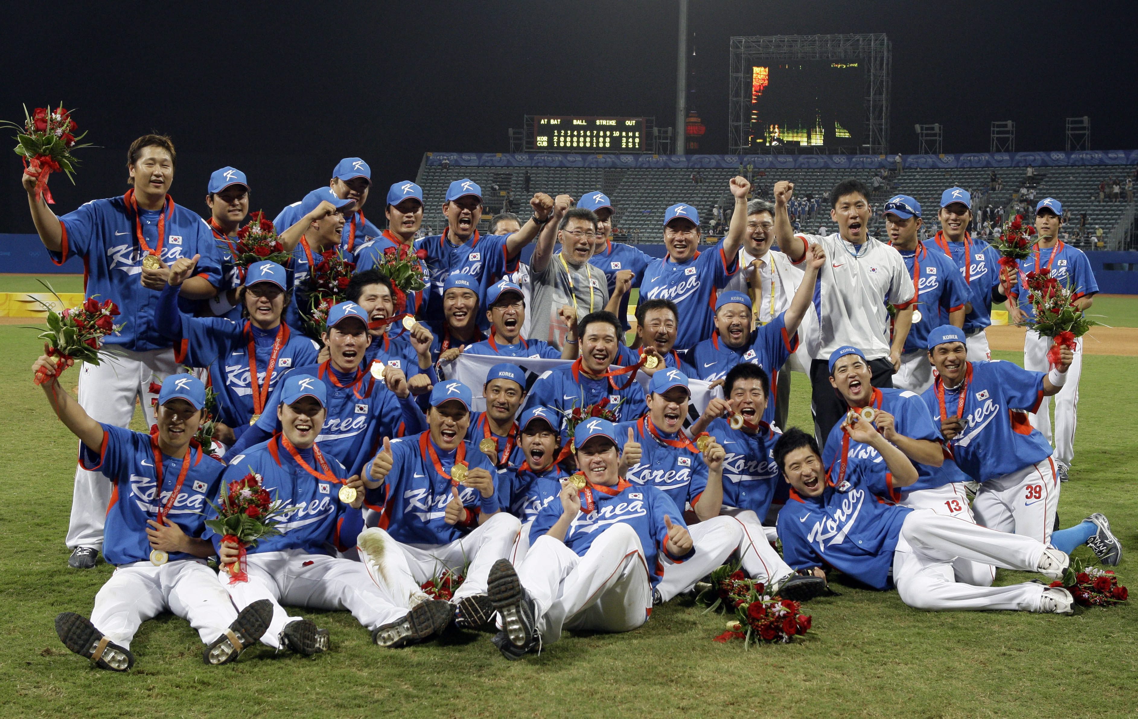 South Korea players celebrate with their gold medals after beating Cuba 3-2 in the gold medal baseball game at the Beijing 2008 Olympics in Beijing, Saturday, Aug. 23, 2008. (AP Photo/Kathy Willens)